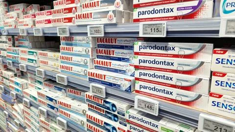 Assortment of toothpaste on a shelf in a store Stock Photos