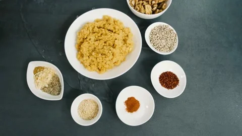 Assortment of various kinds of spices on the table. Water pouring out on the Video stock 133252220