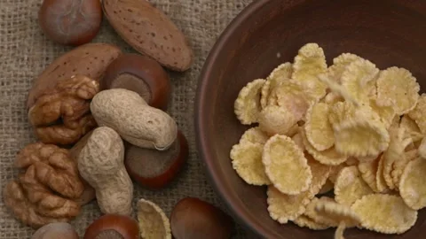 An assortment of various nuts and snack cereals displayed on a rustic wooden Stockbeeldmateriaal 289996835