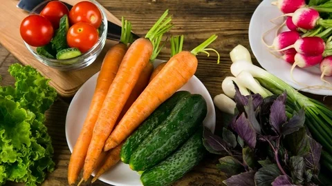 Assortment of vegetables on wooden table Stock Footage 82662371