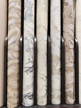 Assortment of wallpaper rolls in a wide range of colors and designs, ready .. 스톡 사진