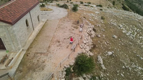 Asteroid effect aerial shot made with drone of a cyclist on top of the mountain Video stock 138511433