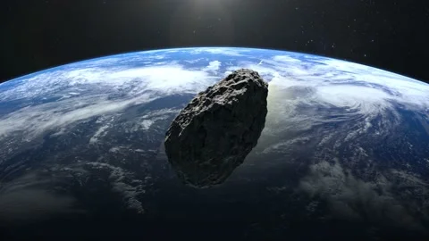 An asteroid falls to Earth. The asteroid spins and flies rapidly towards Earth Stock Footage 141872250