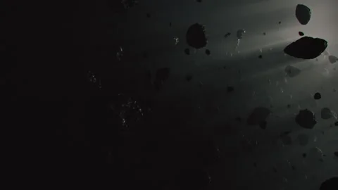 An Asteroid Field in darkness of space flying around Stock-Footage 240393153
