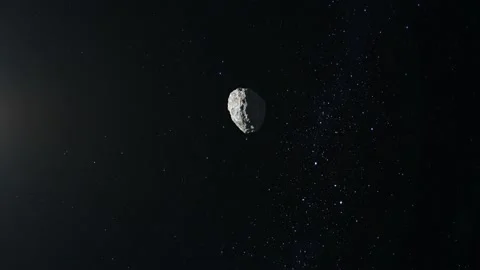 The asteroid flies and rotates in space. The asteroid appears on the screen and Stock Footage 140469713