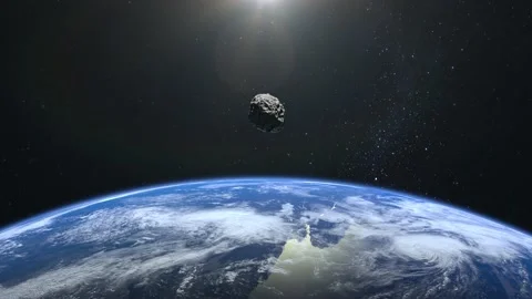 An asteroid flies close to the Earth. The asteroid flies away and rotates Stock Footage 141002138