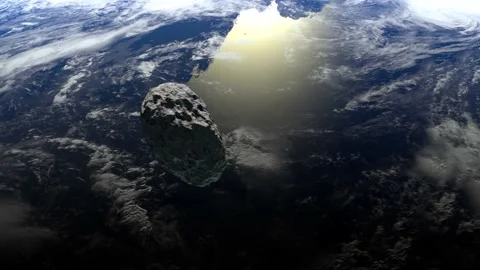 The asteroid flies over the Earth to the right and rotates slowly. 4K. 3d Stock Footage 141389355