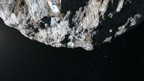 The asteroid flies in space. The asteroid slowly flies away from above. Starry Stock Footage 144071630