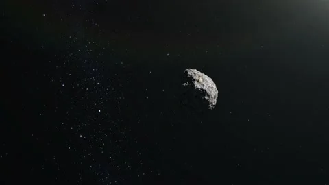 The asteroid is flying in space. Stars twinkle. The asteroid rotates and flies Video stock 140469645
