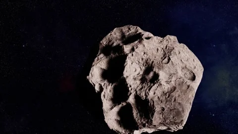 An asteroid is moving and spinning through space Stock Footage 249265542
