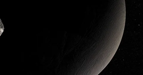 An asteroid tumbles slowly in space as it passes Enceladus. Stock-Footage 91708013