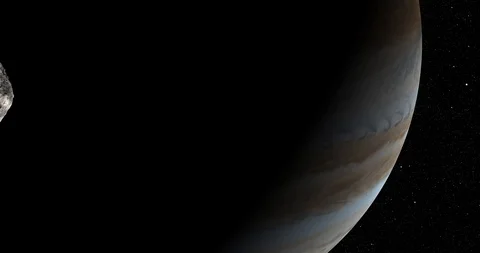 An asteroid tumbles slowly in space as it passes Jupiter. Stock Footage 91713191