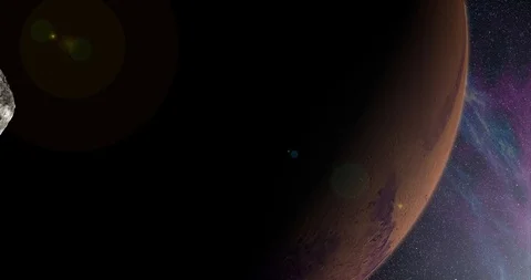 An asteroid tumbles slowly in space as it passes Mars. Lens fx, nebulae 動画素材 91798510