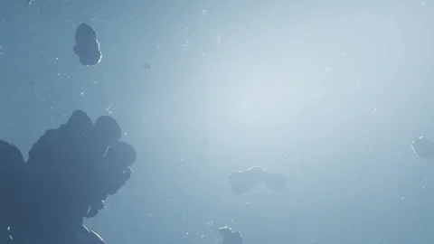 Asteroids drifting in space with bright light source in the background Stock Footage 344313803