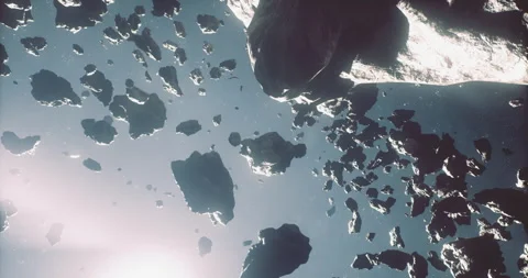 Asteroids drifting through the vastness of space with glowing light effects 動画素材 325031420