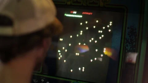Asteroids - Young Man playing Asteroids in the Arcade Stock Footage 87186502