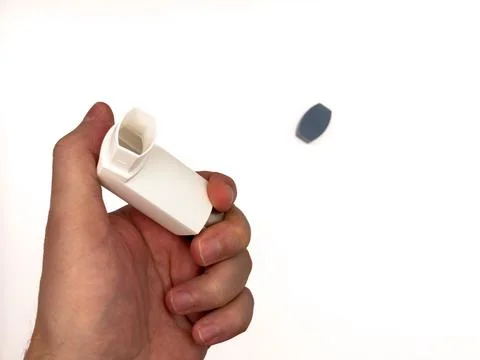 Asthmatic attack. Asthma inhaler device on a white background. Breather for Foto stock