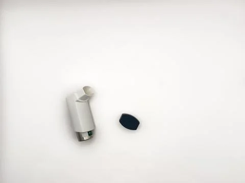 Asthmatic attack. Asthma inhaler device on a white background. Breather for Stock Photos