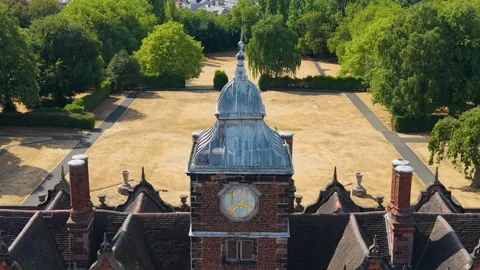 Aston Hall clock tower drone descent with parallax over drought-stricken formal Stock Footage 344092995