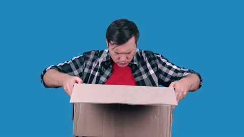 Astonished Caucasian man received a wrong order or an empty cardboard box. Stock Footage 147455306