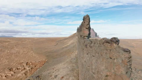 Astonishing drone shot over sharp rocky range in the middle of empty dry land Видео 170462941
