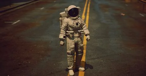 Astro explorer walks on empty road in unusual urban setting at night Stock Illustration