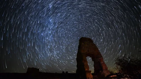 Astro Time Lapse of Star Trails over Abandoned Scenic Ruin -Tilt Down- Stock Footage