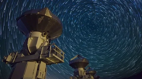 Astro Timelapse of Star Trails over Array of Radio Observatories -Zoom In- Stock Footage 69213945