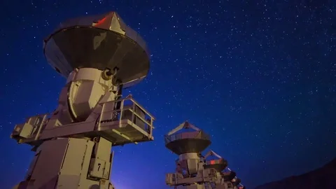 Astro Timelapse of Starry Sky over Array of Radio Observatories -Long Crop- Stock Footage 69214132