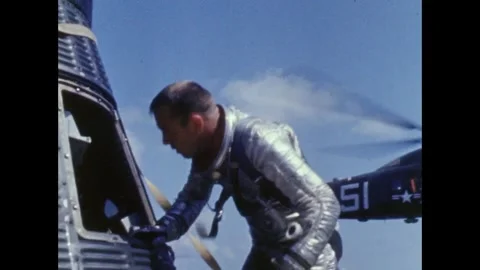 Astronaut Alan B Shepard recovers helmet from Freedom 7 capsule Stock Footage 263292395