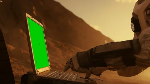 Astronaut on the Alien Red Planet/ Mars Works on a Mock-up Green Screen Laptop.  Stock Footage 86891144