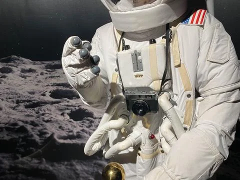 Astronaut with a camera makes a photo. The elements of this image furnished b Stock Photos