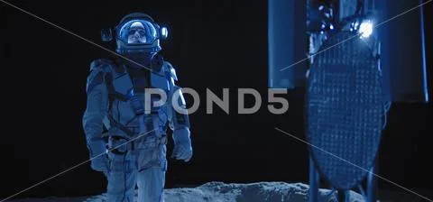 Astronaut checking equipment on Moon Stock Photos