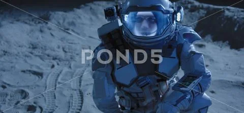 Astronaut checking his surroundings on Moon Stock Photos
