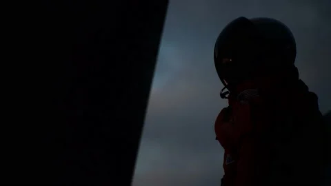 Astronaut choreographs sci-fi moves under glowing clouds Stock Footage 139900233