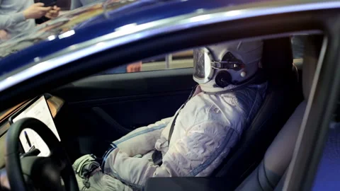 Astronaut in an electric car Stock Footage 87042399