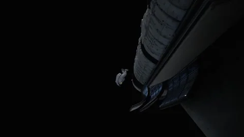 The astronaut faces a problem in zero gravity and floats Stock Footage 260670265