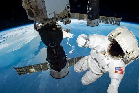 Astronaut float in the space in weightlessness working on the spaceship near to Stock Photos