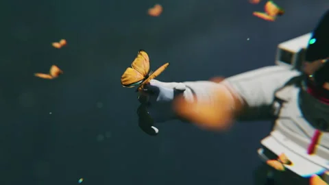 An astronaut floating in space and playing with butterflies in a 3D animation Stock Footage 253572971