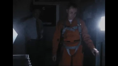 Astronaut Frank Borman inside NASA centrifuge, and technician assist- 1962 Stock Footage 101918699