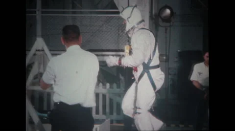 Astronaut in full spacesuit preparing to enter spacecraft couch Stock Footage 37597086