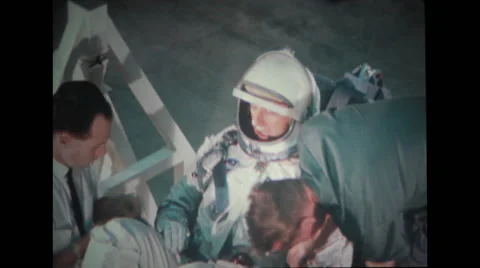 Astronaut in full spacesuit sitting on spacecraft couch Stock Footage