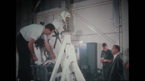 Astronaut getting up from couch with help of technicians Stock Footage 37597099