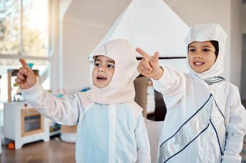 Astronaut, home and children pointing, playing and role play space travel Stock Photos