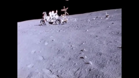 Astronaut John Watts Young drives a Lunar Roving Vehicle, bouncingly, kicking up Stock Footage 86138216