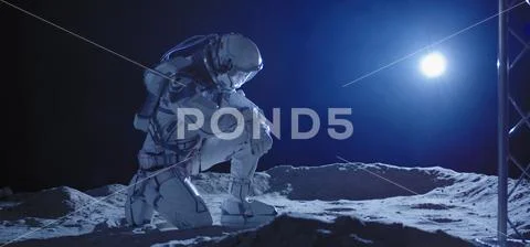 Astronaut kneeling on the Moon Stock Photos