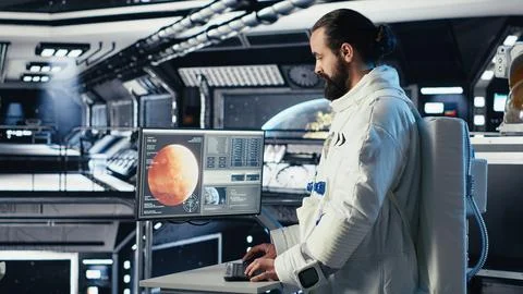 Astronaut looking at planet visualization before stepping out of space station Stock Photos