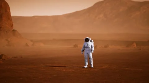 Astronaut on Mars Surface. Red Planet Covered in Gas and rock Stock Footage 157163697