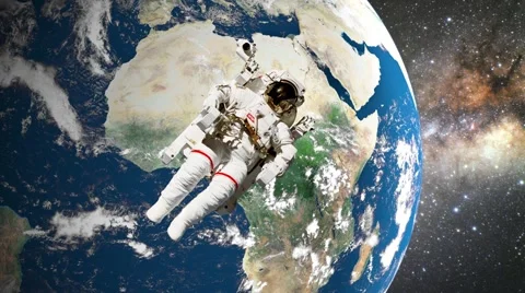 Astronaut in open space in front of earth Stock Footage