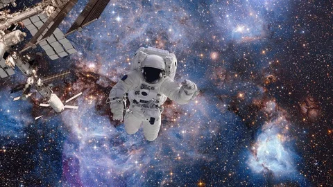 Astronaut in outer space against the background of a galaxy and a cluster of Stock Footage 107538507